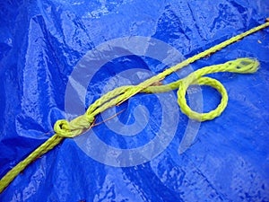 Yellow rope on blue tarpaulin