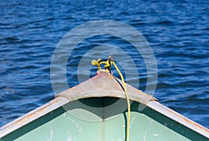 Yellow rope in front of a shallop on a lake