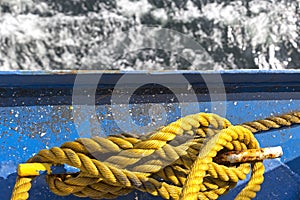 Yellow rope, or a mooring line on a ship. The colour contrast of blue and yellow is beautiful