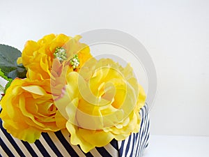 Yellow rose artificial flower in the box with space copy background