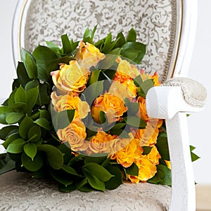 Yellow roses lying on a chair