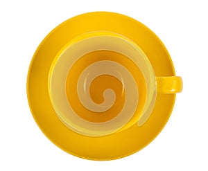 Yellow round empty tea cup on a saucer