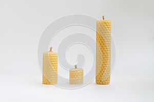 Yellow round wax candles with a honeycomb pattern