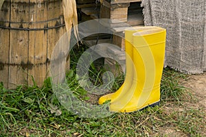 yellow rubber boots on the farm