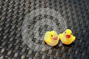 Yellow rubber duck on a background of black wooden.