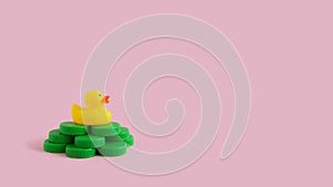 Yellow rubber duck on a green plastic waste pollution island  on a pink pastel background. Polluted environments.