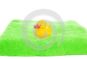 Yellow rubber duck toy and green towel