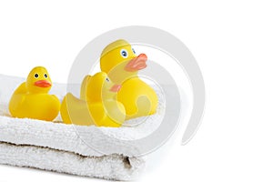 Yellow rubber ducklings on a white terry towel