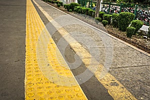 Yellow rubber sign with arise dots to direct blind people at Depok station photo taken in Depok Indonesia