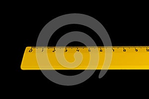 Yellow ruler on a black background 10 centimeters