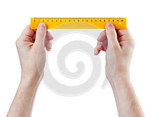 Yellow ruller in hands measure isolated on white
