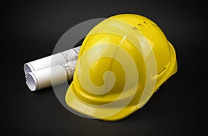 Yellow safety hard hat with engineering drawings