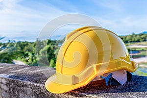 Yellow safety helmet on concrete