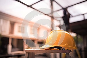 The yellow safety helmet at construction site with sunlight