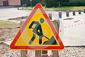 Yellow safety sign warns about roadworks. Under Construction sign