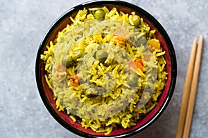 Yellow Saffron Basmati Rice with Turmeric and Vegetables Pilav or Pilaf in Bowl with Chopsticks.