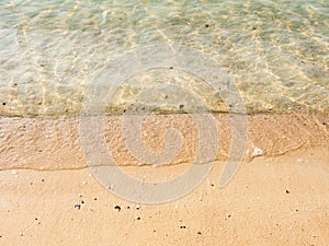 Yellow sand and clear blue ocean water background