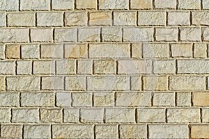 Yellow sandstone bricks wall background abstract texture.