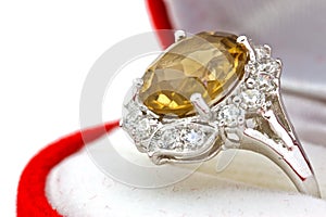 Yellow sapphire ring on white isolated background
