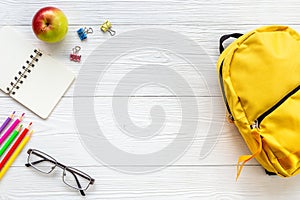 Yellow school backpack with student accessories. College and school concept