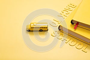 Yellow school bus with books and an inscription back to school. concept photo