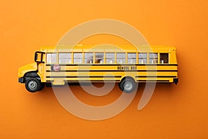 Yellow school bus on orange background. Transport for students