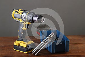 Yellow screwdriver with drill bits