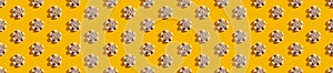 Yellow seamless background white snowflake pattern