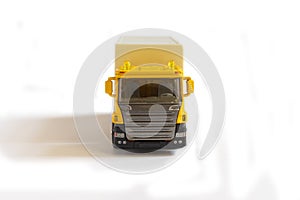 A yellow semi truck with a white trailer attached. Isolated on a white background. Clipping path included