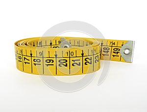 Yellow sewing tape measure isolated on white background. Front view of body measurement ruler, with centimeters and inches