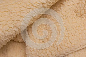 Yellow sheep material wool fur soft structure fleece fabric background texture warm natural nature skin