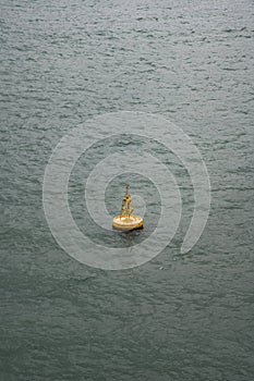 Yellow ship navigation beacon on the sea