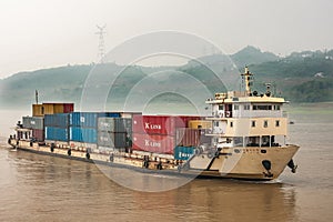 Yellow shipping container boat on Yangtze River, China