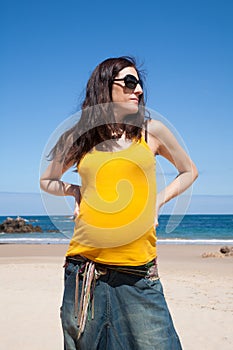 Yellow shirt pregnant woman at beach