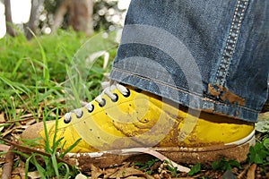 Yellow shoes full of mud