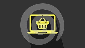 Yellow Shopping basket on screen laptop icon isolated on grey background. Concept e-commerce, e-business, online