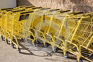 Yellow shopping carts sitting outside the store.