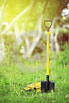 Yellow shovel and hose pipe