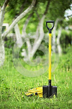 Yellow shovel and hose pipe