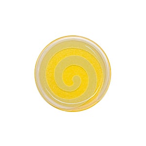 Yellow shower gel scrub container isolated on white background from top view. Sugaring