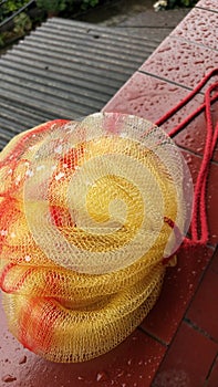 Yellow Shower puff with red line, under the rain, background red floor and fibre cement