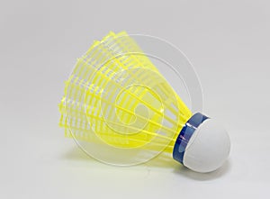 The yellow shuttlecock or badminton ball in white background with copy space