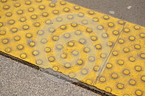Yellow sidewalk plate round with knobs