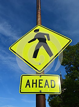 A yellow sign alerting for pedestrians ahead