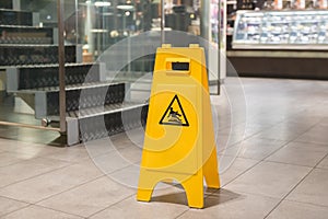 Yellow sign alerts for wet floor