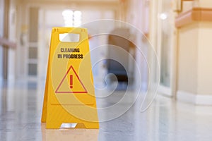yellow sign of caution reserve cleaning on wet floor photo