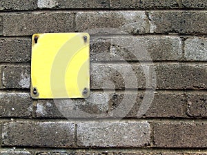 Yellow sign on concrete wall