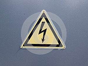 Yellow sign `Danger, high voltage`