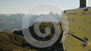 Yellow sign with directons on a hiking trail on a mountain (Austrian Alps)