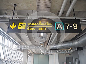 Yellow sign with a gate number at Suvarnabhumi International Airport